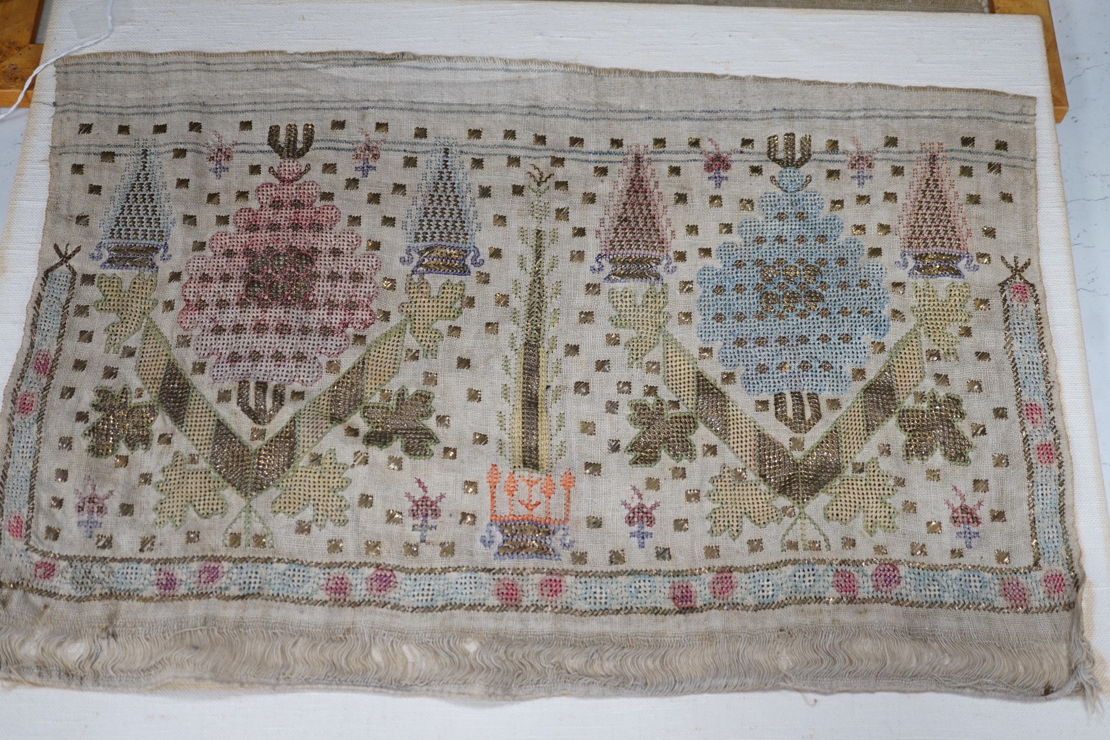 Two 19th century embroidered Turkish towel ends, one framed, 46cms wide x 30cms high